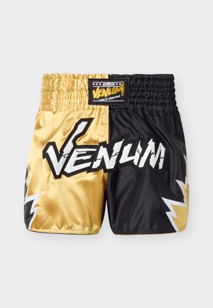 Satijnen korte broek in goud en zwart met brede elastische tailleband, opvallend wit "VENUM" logo aan de voorkant en bliksemschichtontwerpen aan de zijkanten.