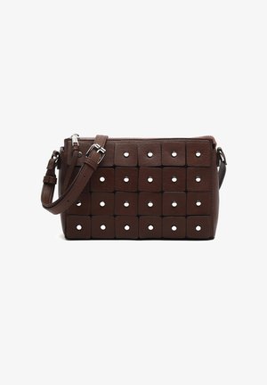 Brown leather crossbody bag with geometric panel design, featuring square accents and circular cut-outs. Adjustable strap and zip closure.