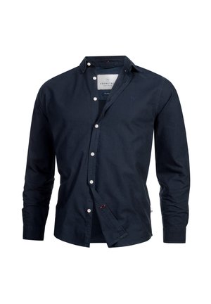 Herrenhemd in Marineblau mit langen Ärmeln, weißen Knöpfen und kleinem, gesticktem Logo auf der Brust, teilweise aufgeknöpft.