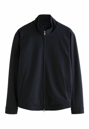Námornícky zip-up kabát vyrobený z mäkkej tkaniny, s vysokým golierom, dlhými rukávmi, dvoma bočnými vreckami a hladkou štruktúrou.