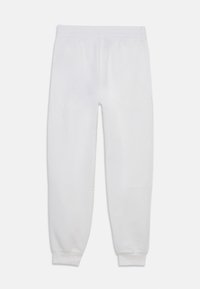 White cotton sweatpants with a smooth texture, elastic waistband, and fitted cuffs, designed for comfort and ease of movement.