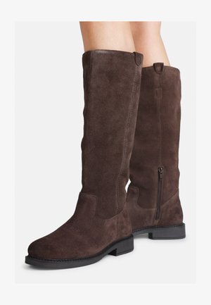Stivali alti fino al ginocchio in suede marrone con suola piatta in gomma nera, zip laterale e dettagli di cucitura lungo le cuciture. Texture liscia con accenti minimi.