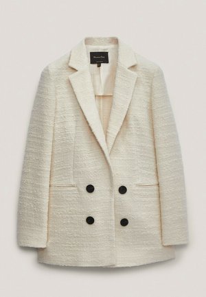 Kremfarvet double-breasted blazer med sortknapper, hakrevers og to forlommer.