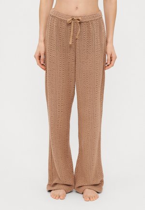 Brede gebreide broek in een lichtbruine kleur, met een textuurpatroon en een drawstring tailleband voor een verstelbare pasvorm.