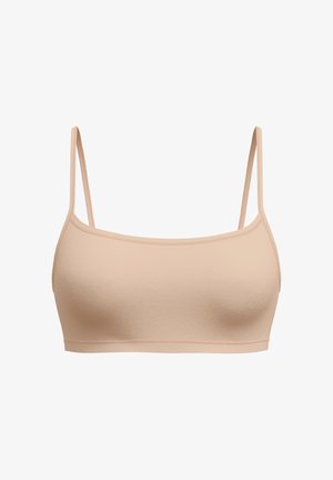 Bralette nude sans coutures avec des fines bretelles ajustables, texture lisse, tissu léger et une bande douce en bas. Détails de conception minimaux.