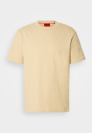 Light yellow cotton t-shirt with short sleeves. Features a round neckline and subtle "HUGO" logo on the front. Smooth texture.