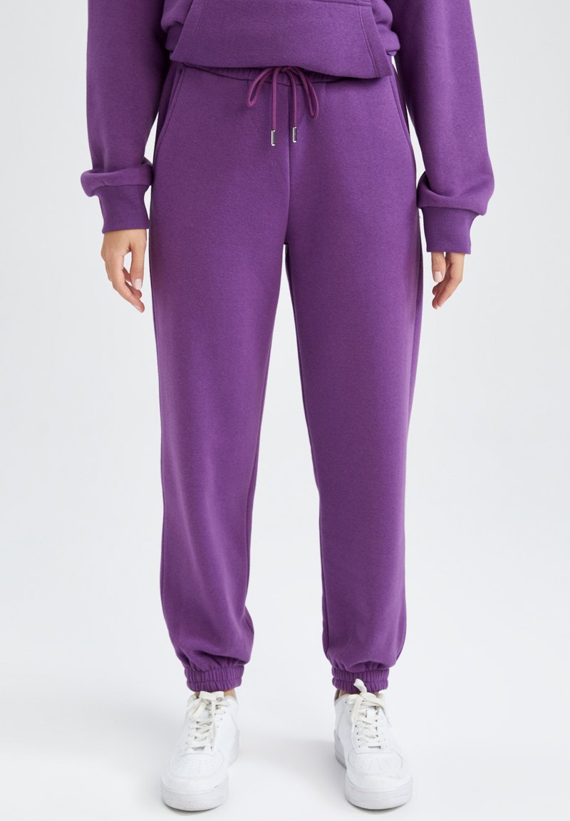 DeFacto Tracksuit bottoms purple Zalando