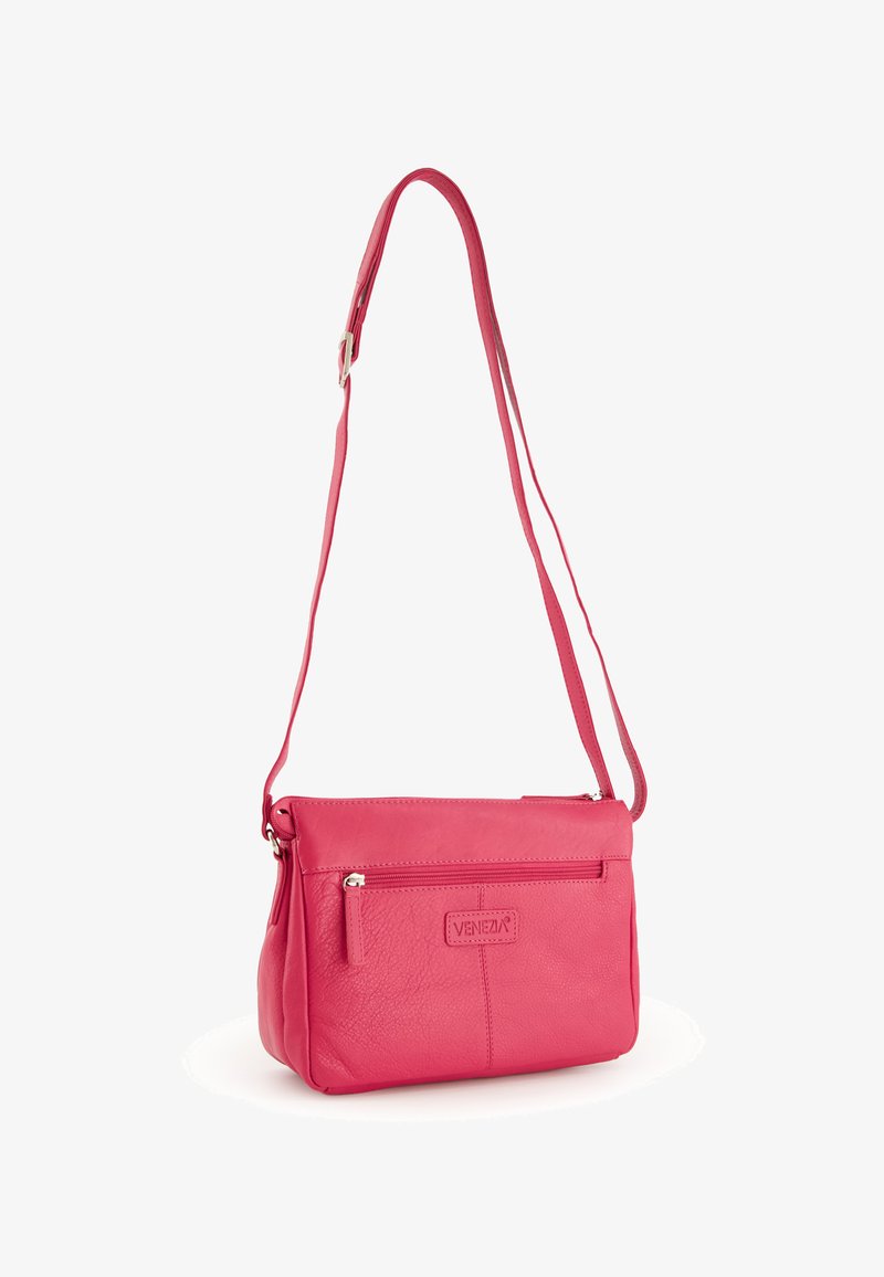 Pink leather crossbody bag with a textured surface, zip closure, and adjustable strap. Features a front zip pocket and embossed logo.