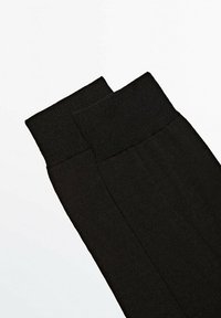 Black leggings with a smooth texture and wide, ribbed waistband. The design is form-fitting with seams running down the sides.