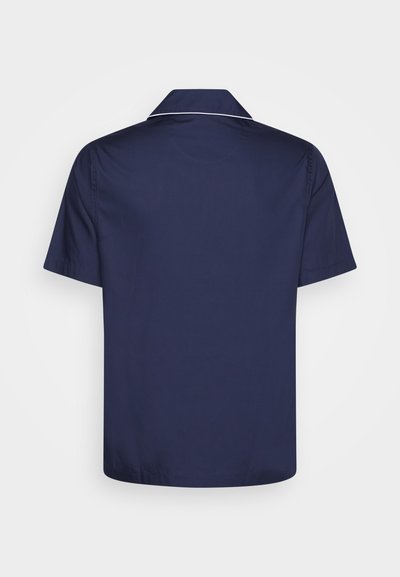 Navy short-sleeve shirt with a relaxed fit, featuring a flat collar and white piping along the neckline. Smooth, lightweight fabric.