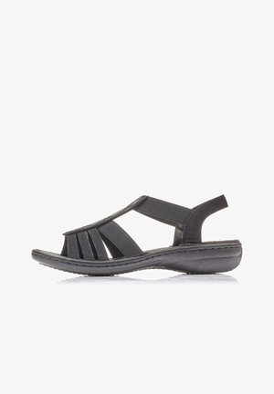 Black sandal made of synthetic material with multiple cutouts, a cushioned sole, and an elastic strap for secure fit. Sleek design.