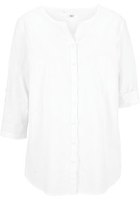 Blouse blanche à boutons en tissu léger. Caractérisée par un col rond, des manches trois-quarts avec poignets retroussés et une coupe ample.