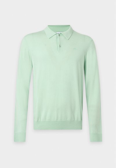 Polo à manches longues vert clair avec col boutonné et manches et ourlet côtelés sur un fond uni.