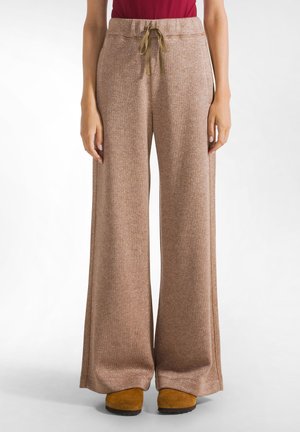 Brown, wide-leg pants with a textured, glittery finish. Features an elastic waistband and adjustable drawstring. Paired with yellow footwear.