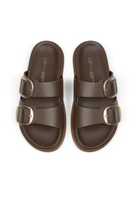 Brown slide sandals featuring two adjustable straps with gold buckles, smooth leather material, and a cushioned footbed for comfort.