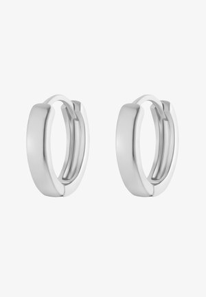 Srebrne kolczyki w kształcie obręczy o gładkim, zaokrąglonym wzornictwie. Lśniąca powierzchnia, średnia szerokość, z hipoalergicznym zapięciem dla łatwego zakupu.