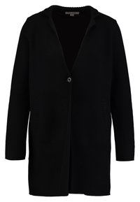 Musta neuletakki, jossa on napitus, avoin etuosa ja sivutaskut pystysuuntaisilla ribbineuloksilla. Pitkät hihat.