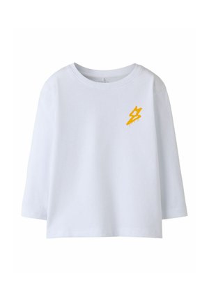White cotton long-sleeve shirt with a round neckline and dropped shoulders, featuring a small yellow graphic on the left chest.