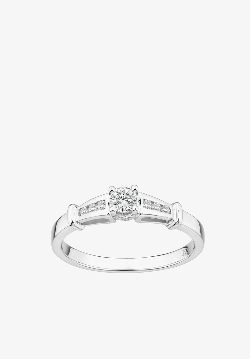 Anillo de plata con un diamante redondo central y dos piedras de acento a cada lado. Banda lisa con acabado pulido y diseño elegante.