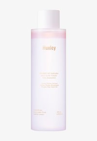 Huxley Skin Glow Toner i en genomskinlig rosa flaska med ett vitt lock. Har guldtext för produktinformation. Innehåller 200 mL.