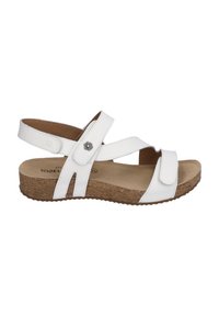 White leather sandal with crisscross straps, a cushioned cork footbed, and a low wedge heel. Features a floral accent on the strap.
