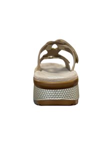 Beige sandal with a smooth, cushioned footbed, metallic accents, and a textured, patterned outsole for grip and stability.