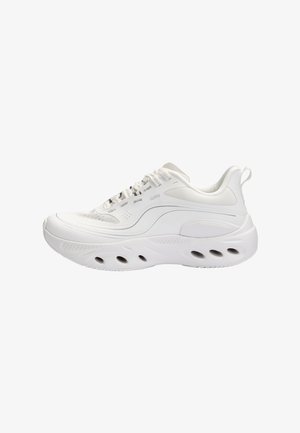 White athletic sneaker with thick sole featuring oval cutouts, lace-up closure, mesh and synthetic upper, and pull tab on the heel.