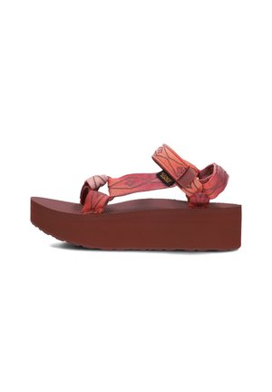 Platform sandals featuring a red textured sole, patterned fabric straps in shades of red and pink, and adjustable ankle straps.