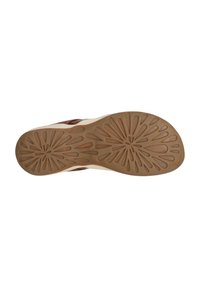 Semelle de chaussure avec un motif de profil, composée de caoutchouc brun avec des rainures florales et des bords crème. Texture lisse dans l'ensemble.