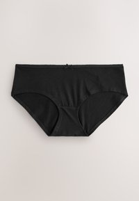 Biancheria intima nera da donna in cotone stile hipster con piccolo dettaglio a fiocco in vita, mostrata distesa su una superficie chiara.