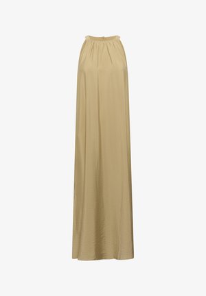 Pasztell sárga anyagú maxi ruha, gyűrött dekoltázzsal, sima textúrával. A modell egy barna vödrös táskát tart, és egy kőkorlát mellett áll.