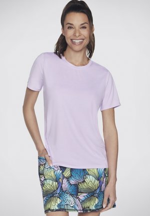 Light purple short-sleeve t-shirt with a round neckline. Paired with a patterned skirt featuring blue and green butterfly motifs.