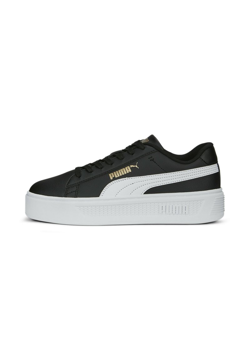 Zapatilla negra con una gruesa suela blanca, que presenta una franja lateral blanca y el logo dorado de PUMA. Material de cuero suave con diseño de cordones.