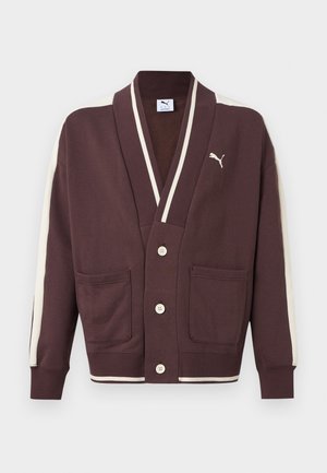 Barna gombos kardigán fehér csíkokkal az ujján és a gallérján, két elülső zsebbel és fehér Puma logóval a bal mellrészen.