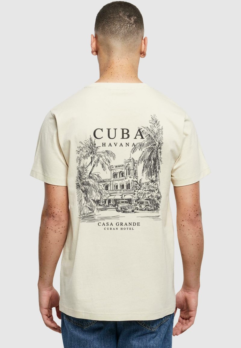 Béžové bavlněné tričko s černou grafikou historické kubánské budovy s palmami a textem "Cuba Havana Casa Grande."