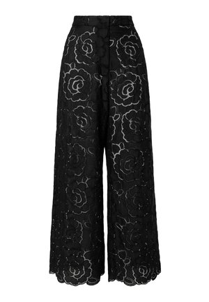 Pantalon large noir à taille haute avec un grand motif ajouré en dentelle florale couvrant le tissu.