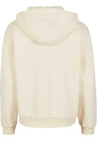 Sweat à capuche beige à manches longues, avec poignets et ceinture côtelés, vu de dos sur un fond blanc.