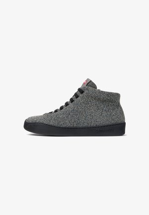 High-top grey shoes made of textured fabric with a black rubber sole, featuring black laces and a small red logo detail.
