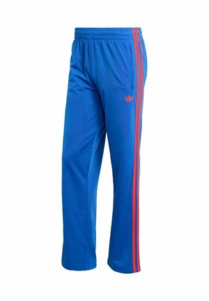 Blue athletic pants made of synthetic fabric. Features red stripes along the sides and an elastic waistband. Includes zippered pocket.