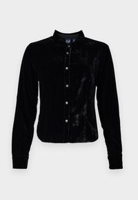 Must mustärda pluus pika varrukaga, krae ja nööbitev eesmise osaga. Sile tekstuur läikiva viimistlusega. Sisaldab hõbedasi nuppe.