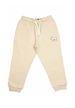 Beige Kinder-Sweatpants mit elastischem Bund, weißem Kordelzug, Bündchen an den Knöcheln und kleinem weißem Hund-Stick auf dem linken Oberschenkel.