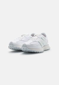 White sneakers with a textured design, featuring mesh panels and iridescent accents. Thick rubber sole with a patterned tread.