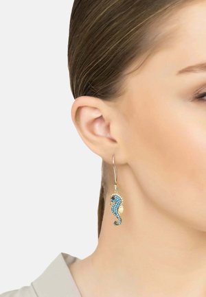Gold-tone hoop earring with a seahorse design, adorned with blue and black rhinestones. Features a detailed tail and fins.