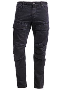 Černé cargo kalhoty vyrobené z odolné tkaniny, s několika bočními kapsami, slim fit a esíčkovými švy na kolenou pro lepší detail.