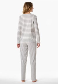 Top de rayas gris y blanco de manga larga con cuello redondo, combinado con pantalones gris sólido. Fabricado con una tela suave, adecuado para ropa de casa.