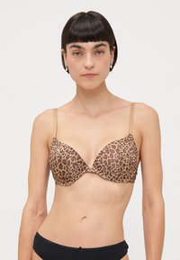 Leopard print bra in shades of brown and tan, featuring a plunge design, adjustable straps, and smooth texture.