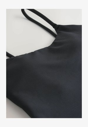 Black tank top with thin straps, made from smooth, stretchy fabric. Features a simple design with no visible patterns or accents.