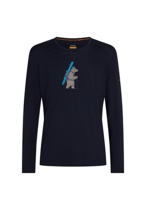 Navy long-sleeve shirt with a graphic of a bear hiking, carrying skis on its back and holding ski poles in the center chest area.