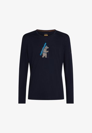Navy long-sleeve shirt with a graphic of a bear hiking, carrying skis on its back and holding ski poles in the center chest area.