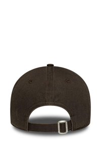 Brown cotton cap with adjustable strap, round crown, and stitched eyelets for ventilation. Plain design with a smooth texture and no patterns.